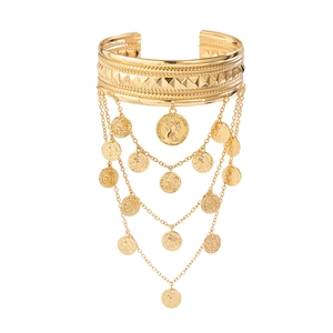 Detail of gold arm chain with vintage coins and multi-layer fringe tassel charms