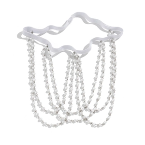 Detail of layered white faux pearl leg chain with elastic band and silver metal links