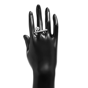 Close-up of minimalist silver geometric ring with metal ball and bar on model hand