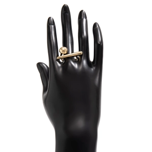 Detailed view of a minimalist golden geometric ring with metal sphere and horizontal bar