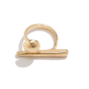 Detailed view of polished gold geometric ring featuring modern metallic spheres and sleek bars
