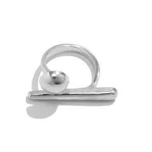 Macro shot of silver metal geometric ring featuring polished spheres and double finger bar