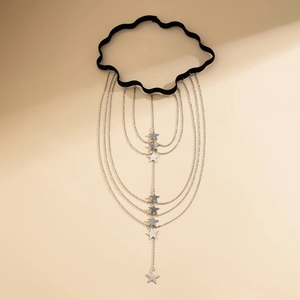 Detail of layered silver star chains dangling from a black elastic butterfly leg chain