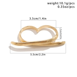 Detailed view of large gold metallic heart double finger ring with dimensions 5.5cm and 3.5cm
