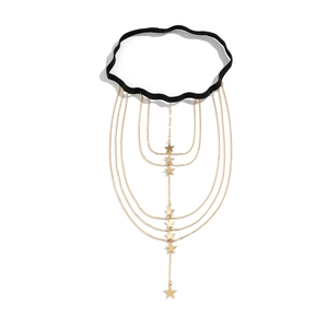 Detail view of multi-layer gold thigh chain with star pendants and black elastic band