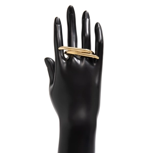 Detailed close-up of a minimalist gold metal multi-finger ring on a black hand model