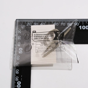 Detailed measurement of silver butterfly ring in transparent packaging with French label