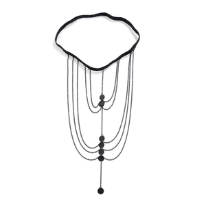 Detail of multi-layer black leg chain with butterfly fringe and star charms for women