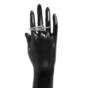Macro shot of silver multi-layered irregular entwined rings on a hand model