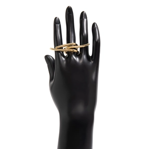 Macro detail of gold layered geometric ring on a black model hand with a smooth metal finish