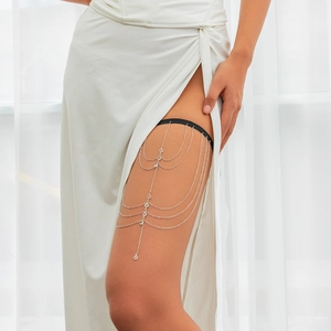 Detail of layered silver leg chain with sparkling rhinestones and elegant tassels