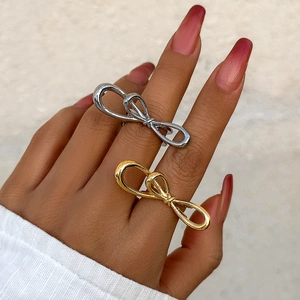 Minimalist metallic butterfly ring in gold and silver finish shown on a hand
