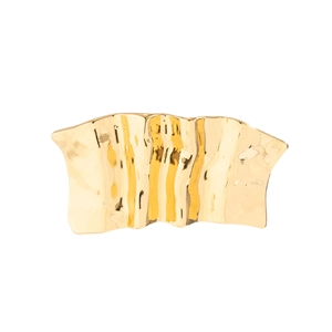 Macro shot of gold-plated metal hairpin featuring irregular molten texture and wavy design