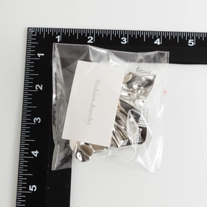 Detailed measurement of the irregular wavy silver metal hairpin with scale ruler
