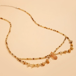 Detalle de cadena de cintura con cuentas de ámbar y piedras naturales de estilo boho