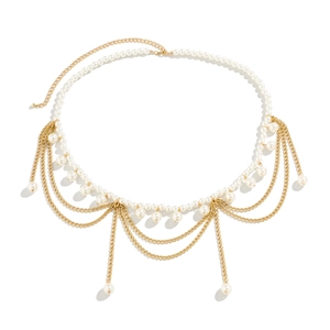 Detail of gold multilayer waist chain featuring white pearls and elegant tassel fringe