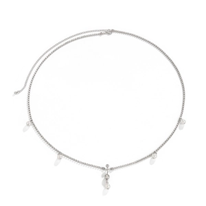 Detalle de la cadena de cintura plateada con pedrería brillante y perlas blancas