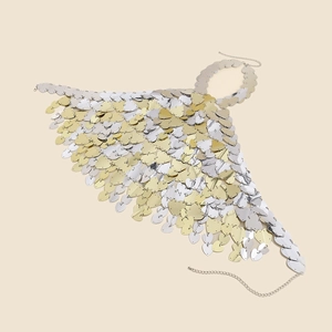 Detail of heart-shaped gold and silver sequins on metallic party body chain top