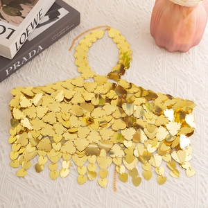 Detail of gold heart sequins and adjustable chains for a metallic bikini body chain