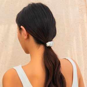 Close-up of a silver irregular crinkle hair clip for ponytail on a female model