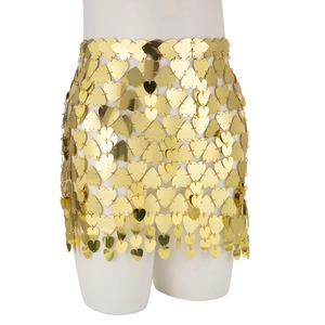 Detail of gold heart-shaped sequins and metal ring links on a body chain skirt
