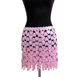 Detailed close-up of pink heart-shaped sequins linked by metal rings on a body chain skirt