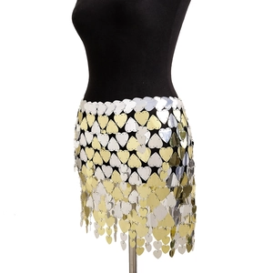 Detail of gold and silver heart sequin fringe body chain on a black mannequin