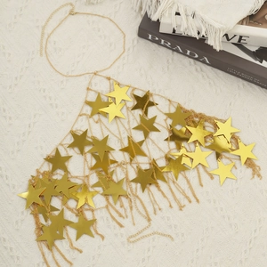 Detailed view of golden pentagram star body chain sequins laid on white textured fabric