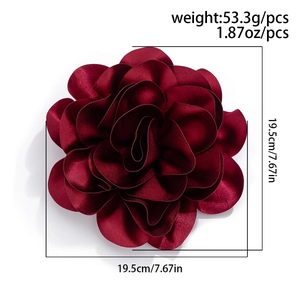 Detailed view of dark red satin flower brooch showing 7.67 inch size and texture