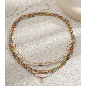 Detail of layered waist chain with colorful beads, natural shells and a starfish pendant