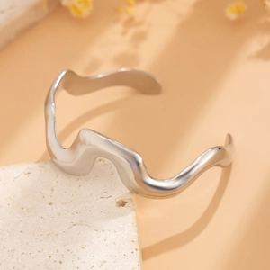 Detailed view of silver liquid lava anklet with irregular wavy texture on stone base