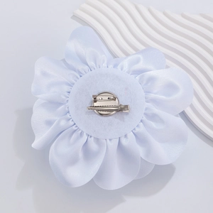 Detailed back view of light blue satin rose brooch pin with silver alligator clip