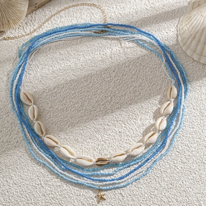 Detail of beach waist chain with starfish pendant, blue beads, and real seashells
