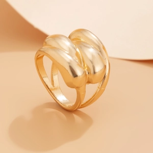 Detailed view of chunky multi-layer knot ring with high-polish gold mirror finish