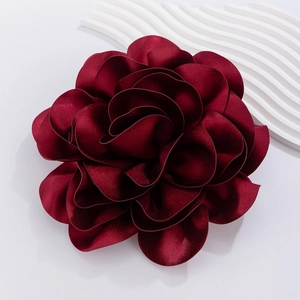 Detail of multi-layered dark red satin rose brooch with realistic petal texture