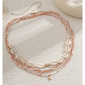 Detail of bohemian layered shell waist chain with starfish pendant and colorful beads