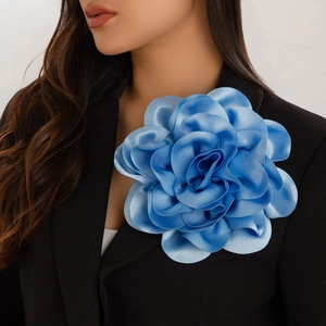 Macro shot of large royal blue satin flower brooch pinned on a black suit lapel