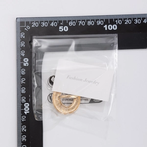 Size measurement of a gold irregular textured hoop earring with Fashion Jewelry card