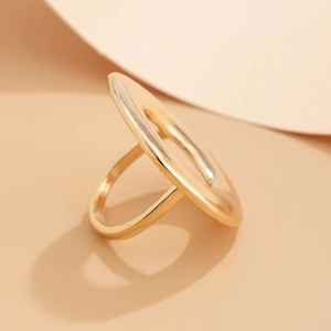 Modern gold-tone minimalist ring with large circular design and brushed metal finish details