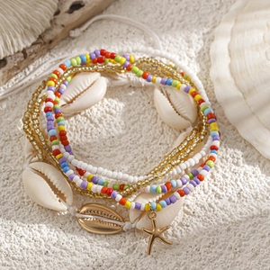 Macro detail of bohemian waist chain with colorful beads, sea shells and starfish pendant