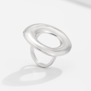 Macro detail of irregular silver teardrop ring with polished liquid metal finish