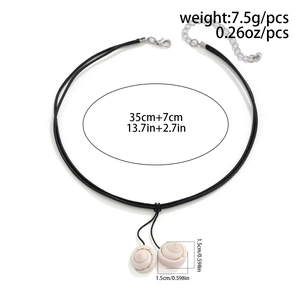 Detail of shell necklace showing two white conch pendants and adjustable cord length