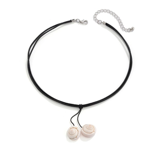 Detail of beach style necklace featuring wax rope and natural conch shell pendants