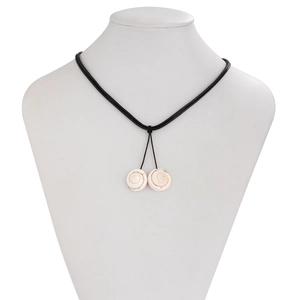 Detail of natural spiral shell pendants on a black minimalist cord necklace for beach style