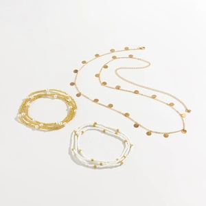 Flat lay detail of multi-layered gold sequin and white bead sexy beach waist body chain