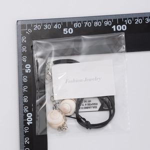 Detail of double shell pendant necklace with black wax cord and adjustable lobster clasp