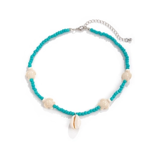 Detail of bohemian starfish necklace with turquoise beads and white sea turtle charms