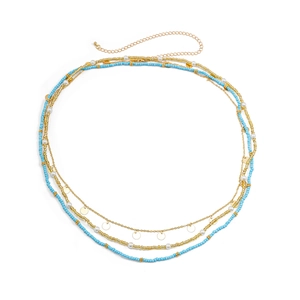 Detail of multi-layer bohemian waist chain with sky blue beads and gold sequins