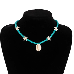 Detail of beaded beach necklace featuring blue turquoise beads, starfish, and shell pendant