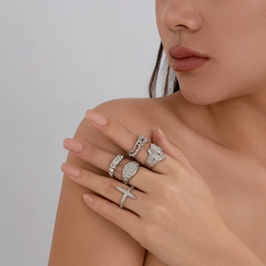Detailed view of five-piece set silver textured rings with irregular molten lava design